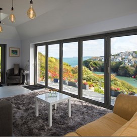Dining room view looking through bifold doors onto a large garden
