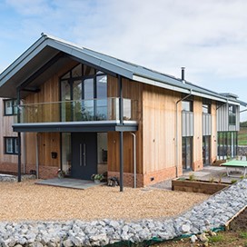Outdoor shot of a barn conversion with bifold doors