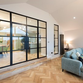 Origin Black Internal Aluminium Doors fit seamlessly as a partition wall between living area and kitchen