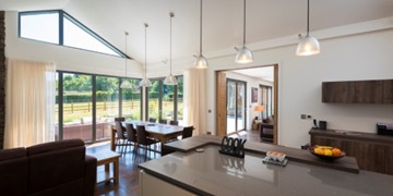 Kitchen to living room bifold doors showing an open living space via bifold doors between the rooms.