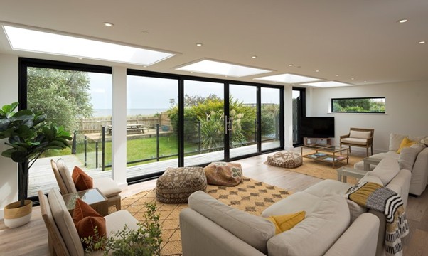 A modern living room looking out onto a garden through closed Origin sliding doors