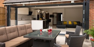 Kitchen to garden bifold doors - Showcasing an open living space using an open garden.