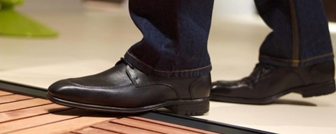 Imaage of a person walking over an Origin Bifold door threshfold.