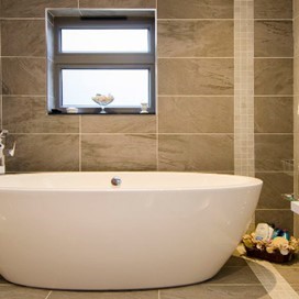 A well presented bathroom with a standing bath