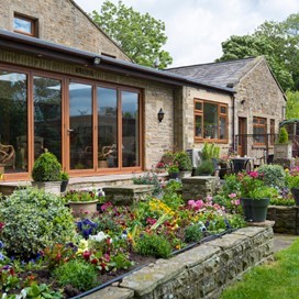 Golden Oak Bi-fold Doors Transform this Conservatory
