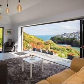 View from inside a dining room looking through open bifold doors