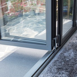 Looking towards the bottom of an open set of bifold doors, with the track visible