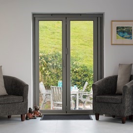 Inside of a home looking through a origin french door looking into a garden
