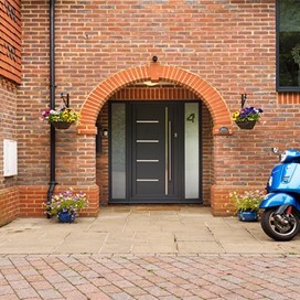 Front facing view of the outdoor of a modern home with view of a black Origin front door