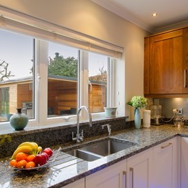A close up of the Origin windows used in a kitchen, looking out into the garden