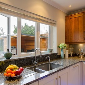 A close up of the Origin windows used in a kitchen, looking out into the garden