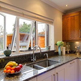 A close up of the Origin's windows used in a kitchen, opening out into the garden