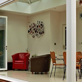 Large open corner doors looking into a room from the garden
