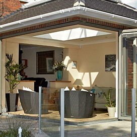 A view from the garden into the extension through open corner doors