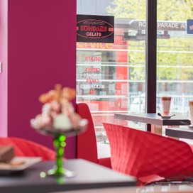 The interior of an ice cream parlour looking out into the street through Origin's windows and glass doors
