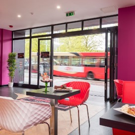 An interior shot of Sundaes Gelato showing the counter, with the doors fully open to the street outside