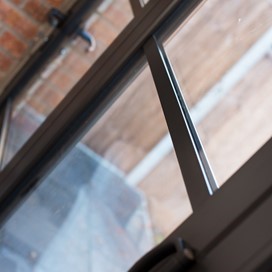 Close up of bifold doors looking over a bright garden