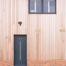 shot of both a black origin door with origin window above