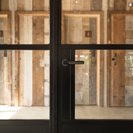 Close up of black bifold doors showing the handle section
