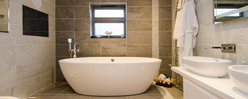 A well presented bathroom with a standing bath
