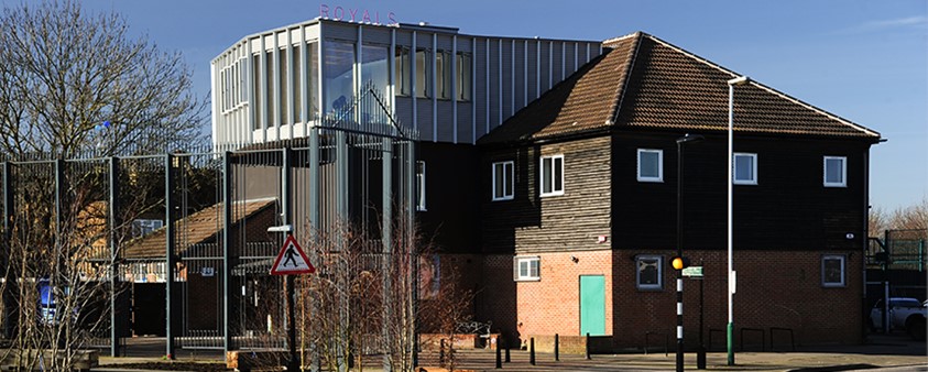 An external shot of the Royals building, showing the original building and the new aluminium windows added to the roof