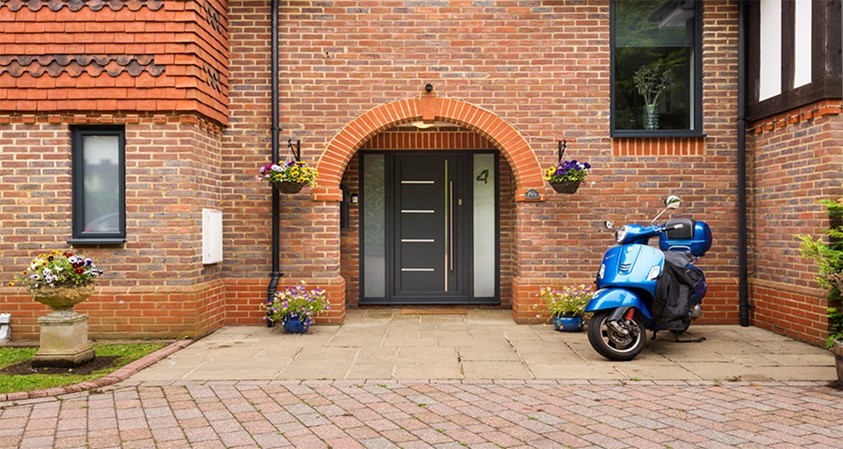 Front facing view of the outdoor of a modern home with view of a black Origin front door