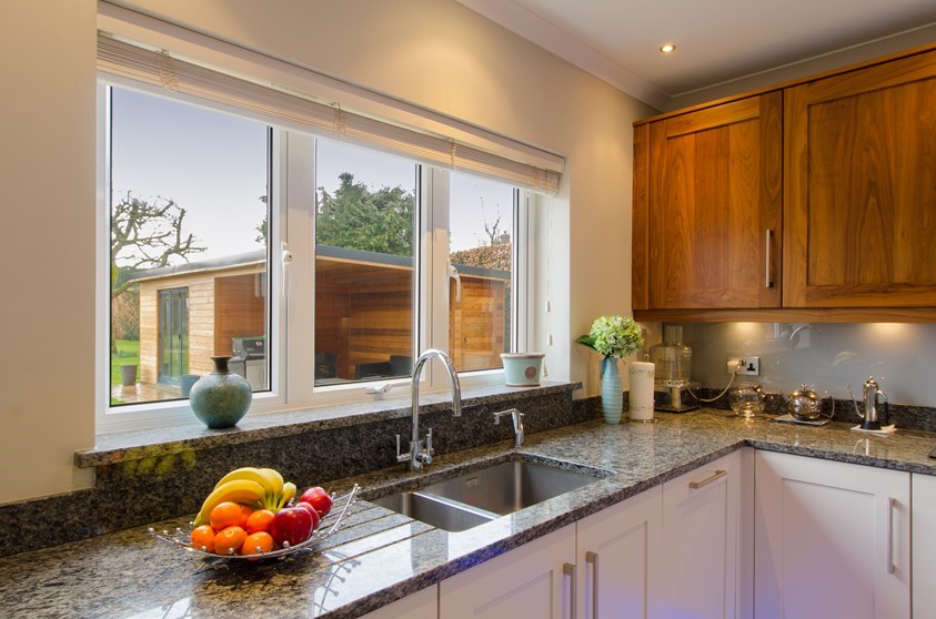 A close up of the Origin windows used in a kitchen, looking out into the garden
