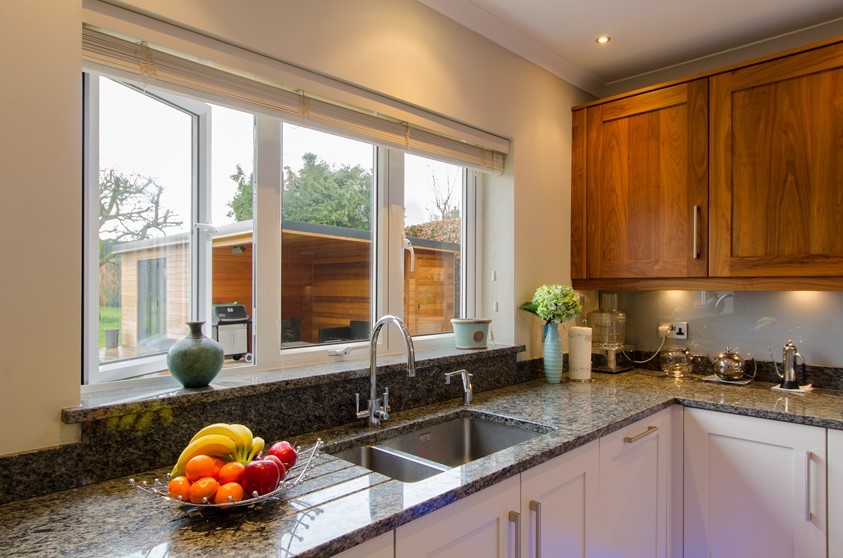 A close up of the Origin windows used in a kitchen, looking out into the garden