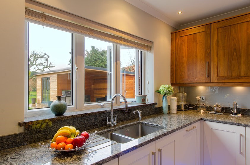A close up of the Origin windows used in a kitchen, looking out into the garden