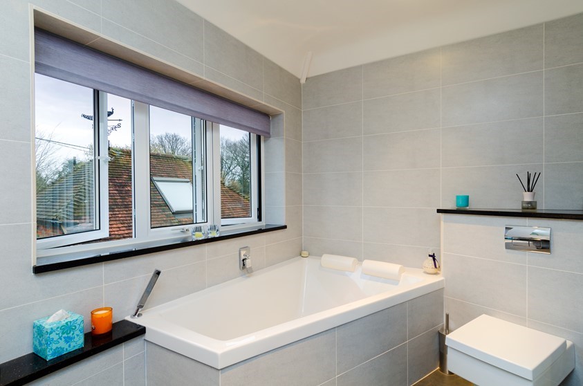 An internal view of an open bathroom windows and blind