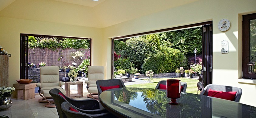 Large open doors from an extension out to the garden in the Sun