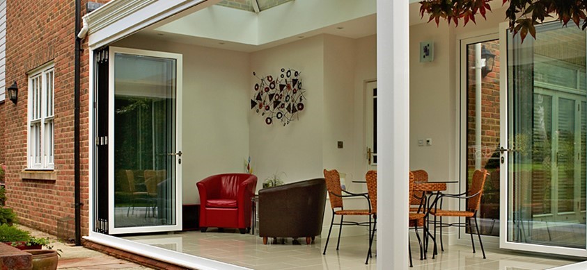 Large open corner doors looking into a room from the garden