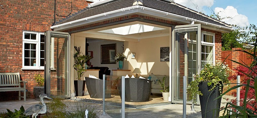 A view from the garden into the extension through open corner doors