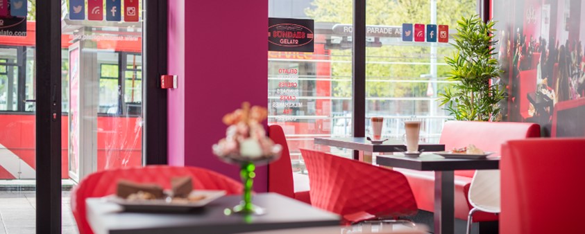 The interior of an ice cream parlour looking out into the street through Origin's windows and glass doors