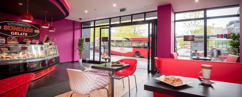 An interior shot of Sundaes Gelato showing the counter, with the doors fully open to the street outside