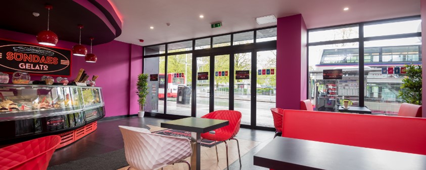 An interior shot showing the counter and some tables of Sundaes Gelato ice cream parlour looking out onto the street