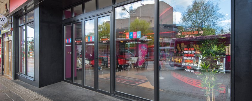 A close up of the shopfront windows of a Plymouth ice cream parlour