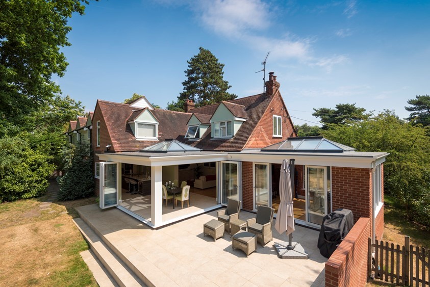 Outdoor view of a whole house with white extension attached