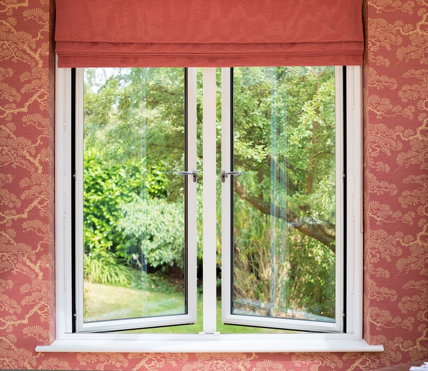 Large origin window half open and slightly covered by red blinds