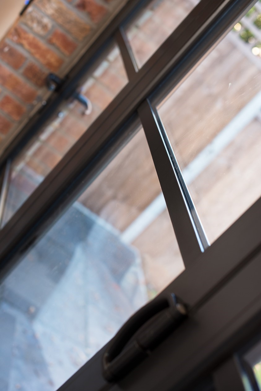 Close up of bifold doors looking over a bright garden