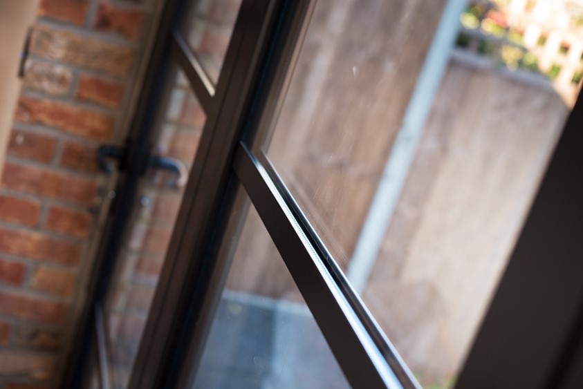 Close up of bifold doors looking over a bright garden