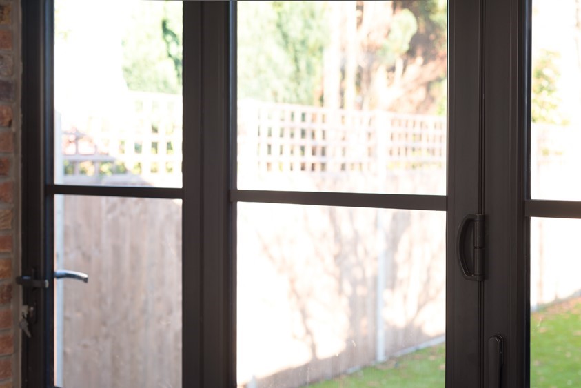 Close up of bifold doors looking over a bright garden
