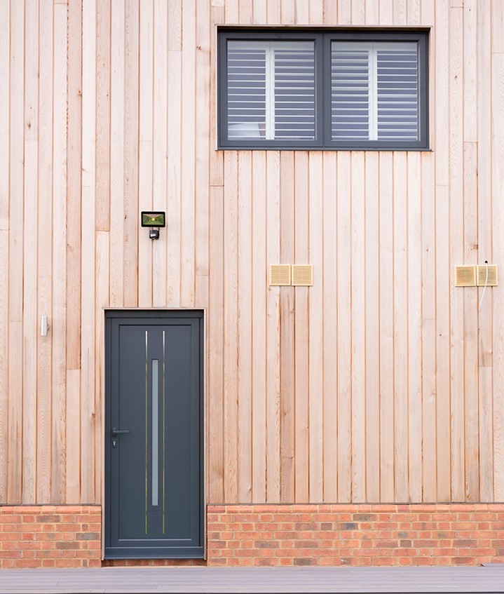 shot of both a black origin door with origin window above