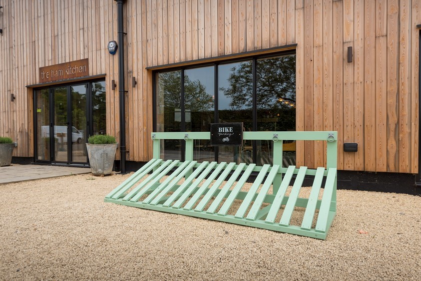 Outside of a farm shop showing a blue bicycle rack