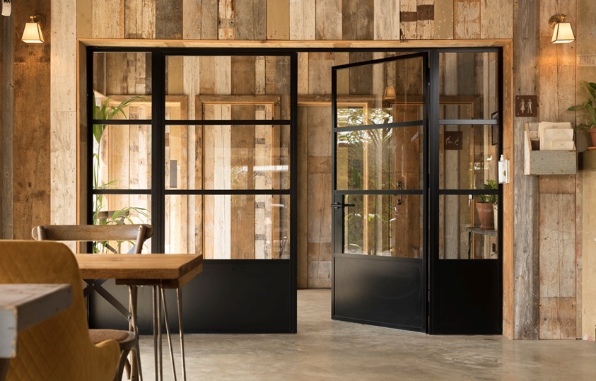 Black bifold doors leading out of the cafe