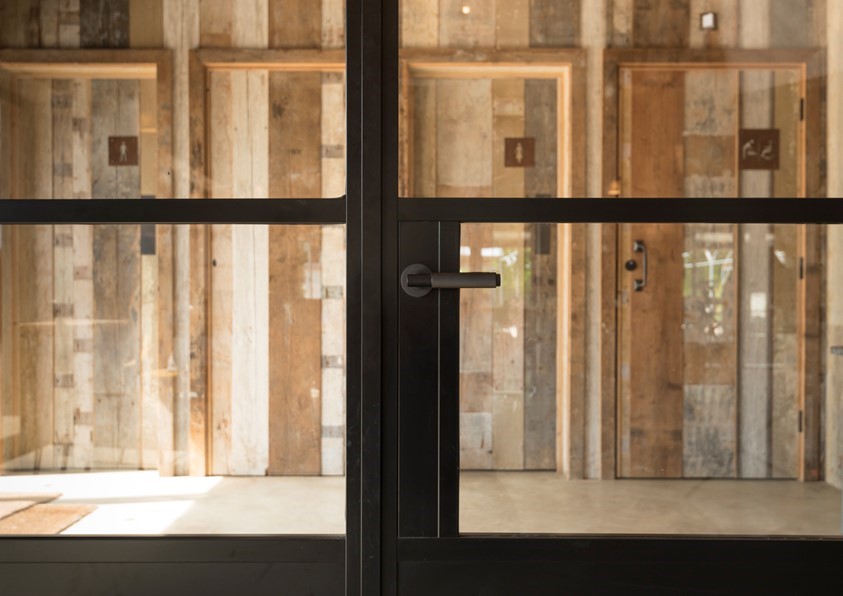 Close up of black bifold doors showing the handle section