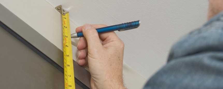 Tradesperson measuring a fit for an Origin window.