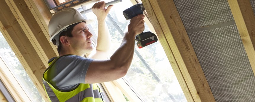 Tradesperson fitting an Origin window into an extension