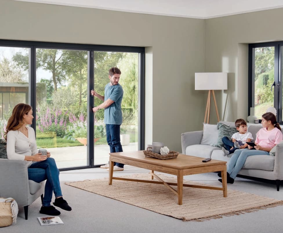 People enjoying origin bifold doors in a living room