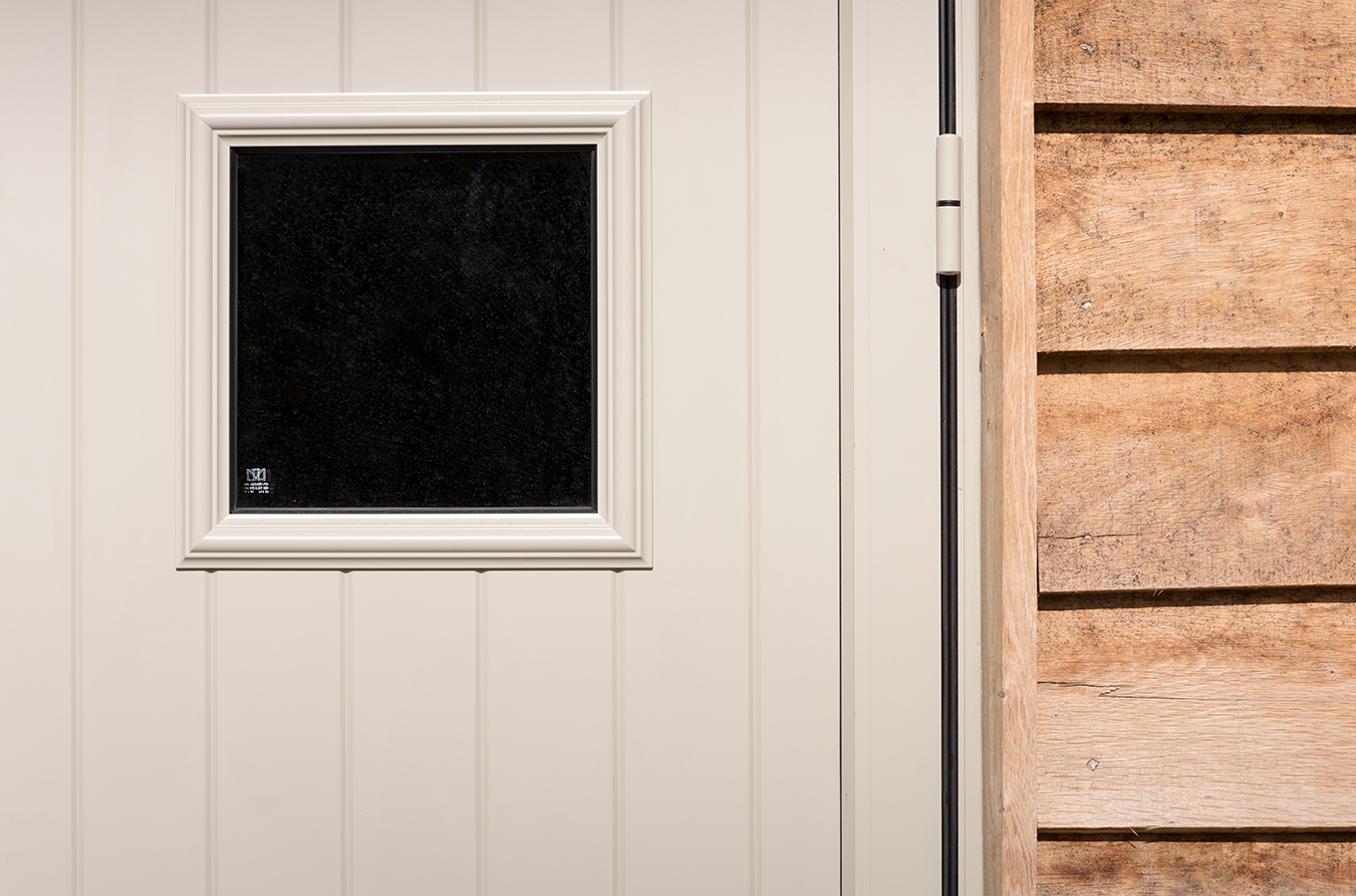 Open front door with a view of green fields stock photo - OFFSET